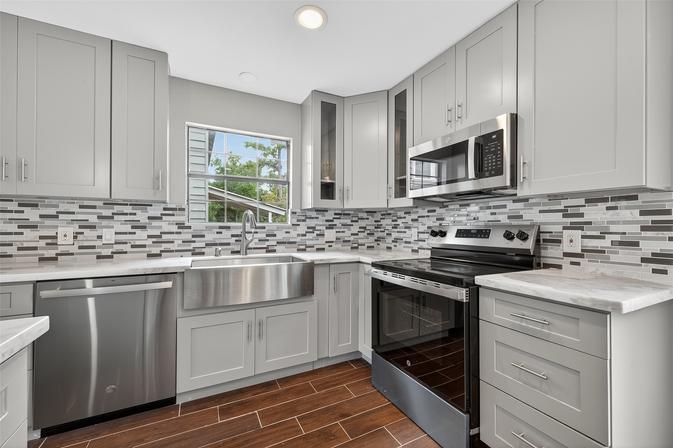 1933 Santa Rosa Street Houston, TX 77023 - Photo 17 of 44 a kitchen with stainless steel appliances granite countertop a sink stove and cabinets