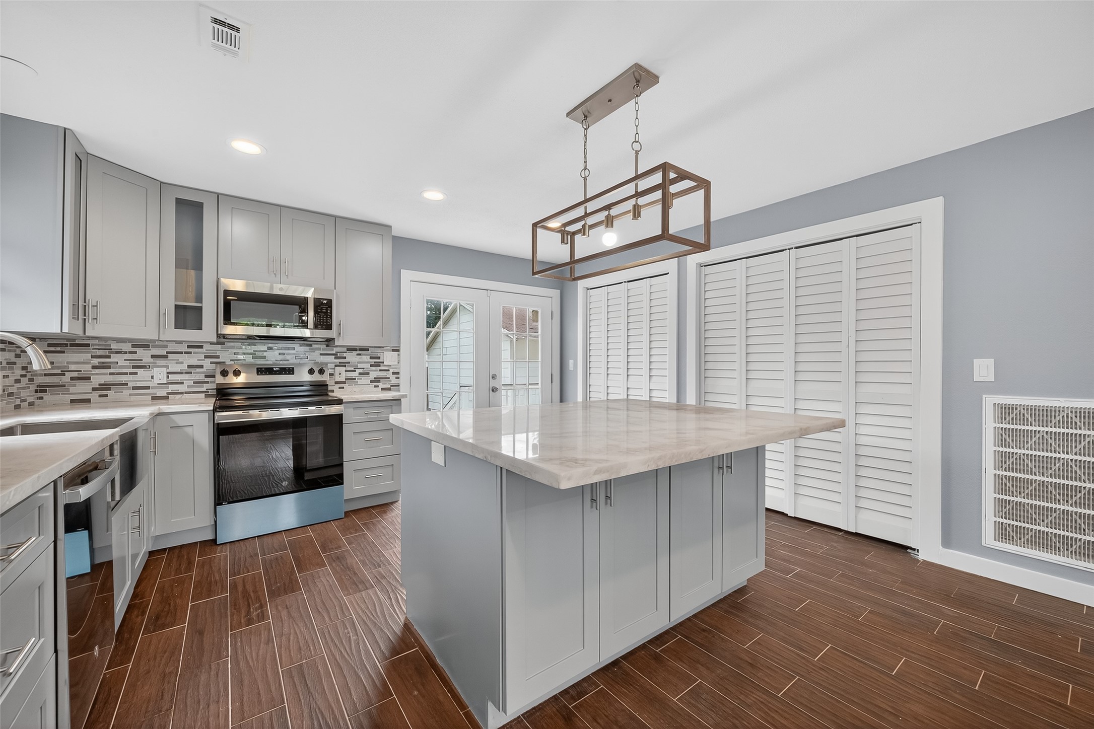 1933 Santa Rosa Street Houston, TX 77023 - Photo 19 of 44 a kitchen with granite countertop stainless steel appliances and wooden cabinets