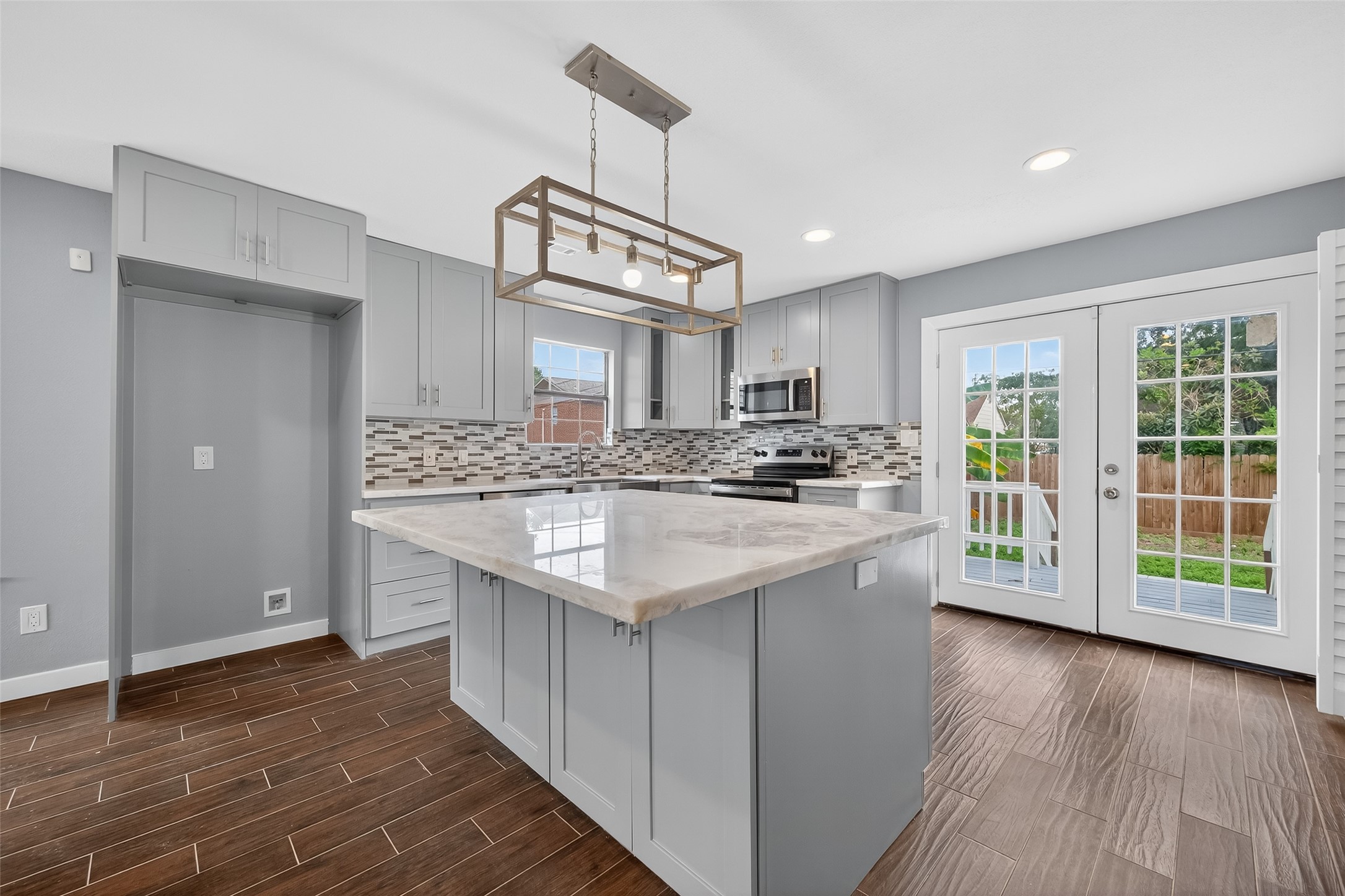 1933 Santa Rosa Street Houston, TX 77023 - Photo 20 of 44 a kitchen with stainless steel appliances granite countertop a sink a stove a refrigerator cabinets and wooden floor