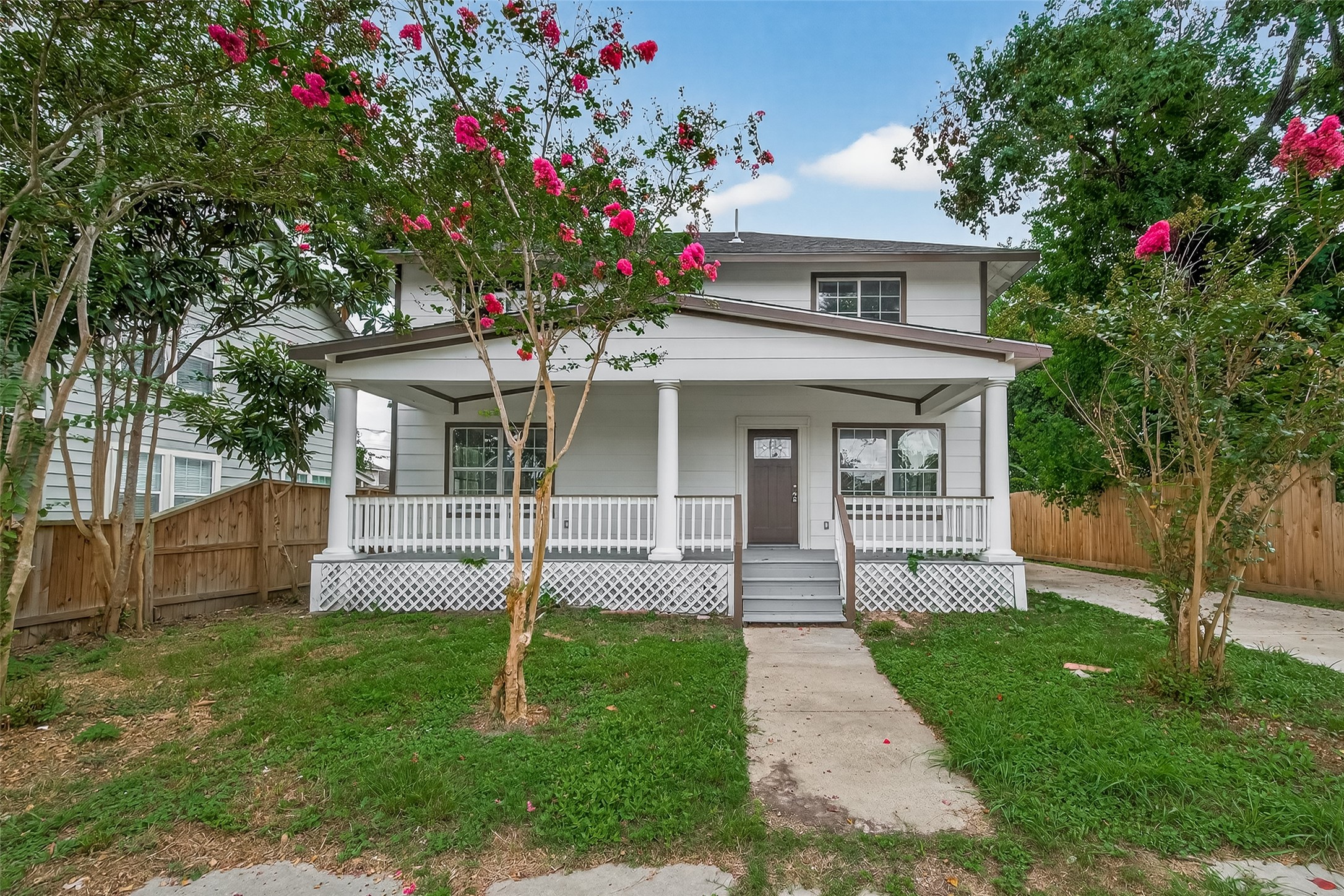 1933 Santa Rosa Street Houston, TX 77023 - Photo 2 of 44 a front view of a house with a garden and trees