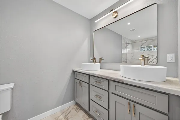 a bathroom with a sink double vanity and a mirror