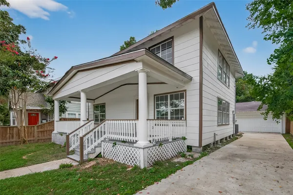 a view of a house with a yard and garden