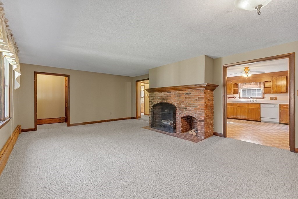 363 North Main Street Petersham, MA 01366 - Photo 11 of 32 an empty room with furniture and a fireplace