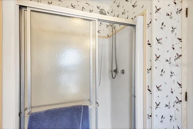 a bathroom with a glass shower door