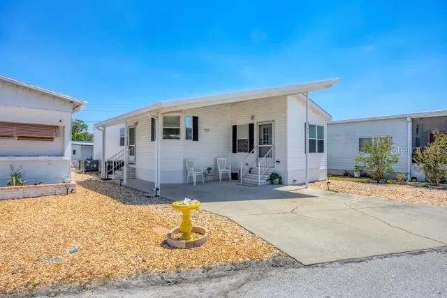 a view of a house with swimming pool and sitting area