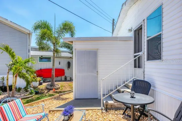 a front view of a house with swimming pool and a fire pit