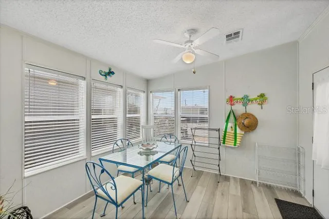 a view of a dining room with furniture and a window