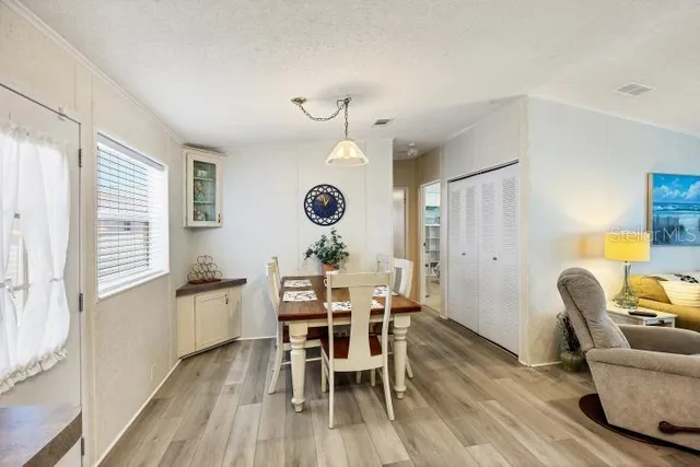 a view of a dining room with furniture and a large window