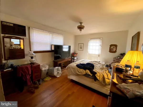a living room with hard wood floors and a window