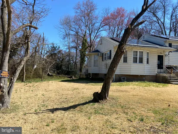 a front view of a house with a yard covered with snow