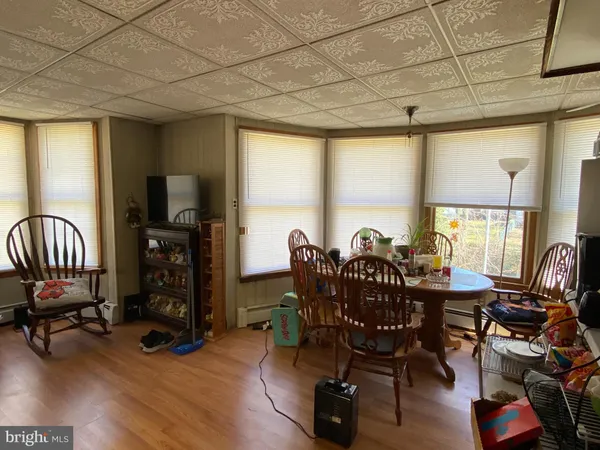 a living room with furniture a flat screen tv and a large window