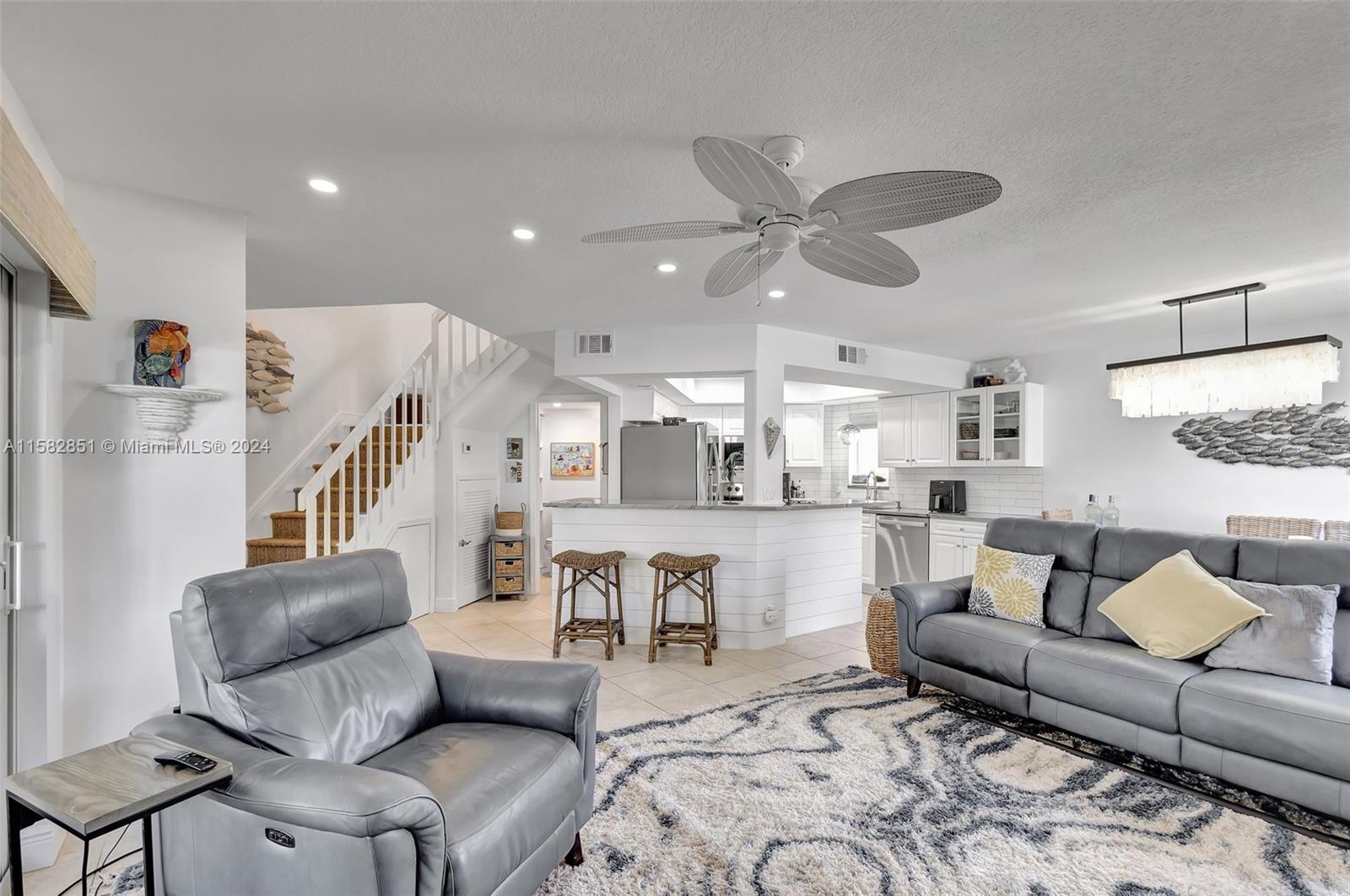 237 Seabreeze Circle Jupiter, FL 33477 - Photo 11 of 63 a living room with furniture and a view of kitchen