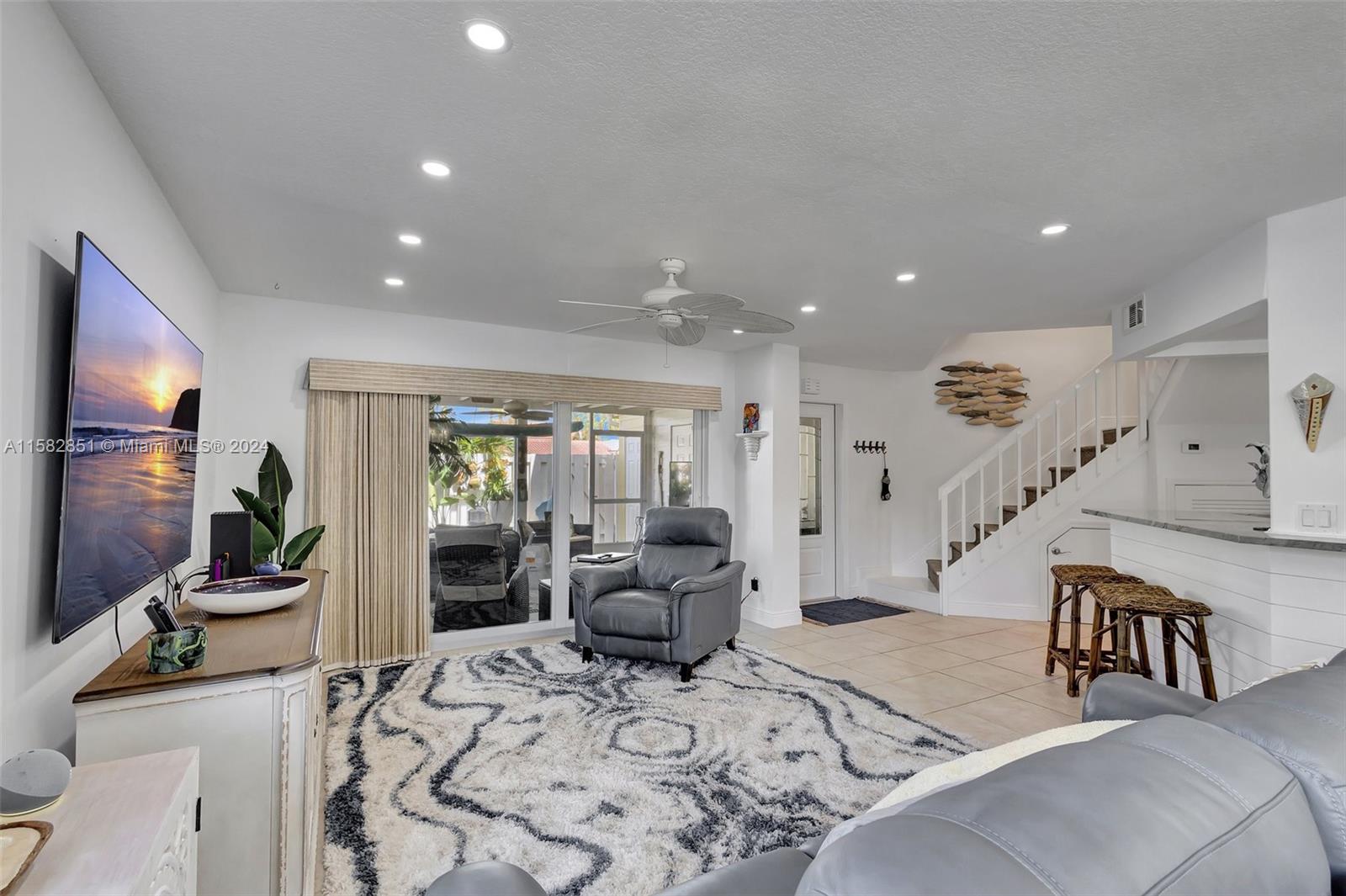 237 Seabreeze Circle Jupiter, FL 33477 - Photo 12 of 63 a living room with furniture and wooden floor