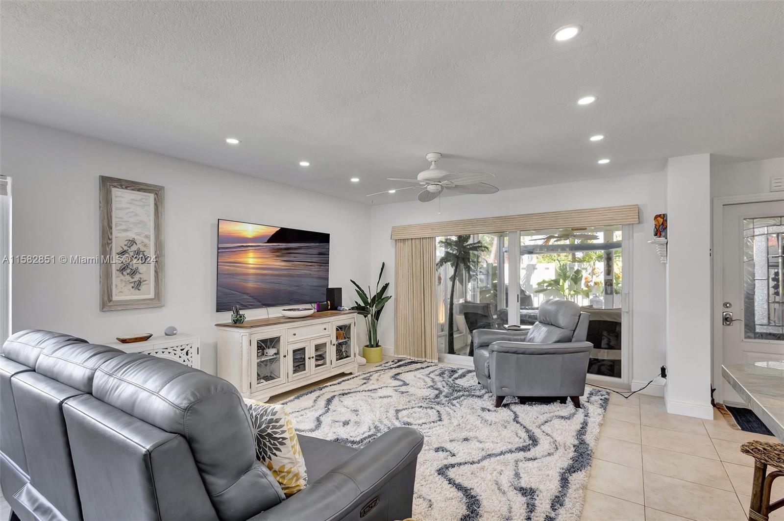 237 Seabreeze Circle Jupiter, FL 33477 - Photo 13 of 63 a living room with furniture and a flat screen tv