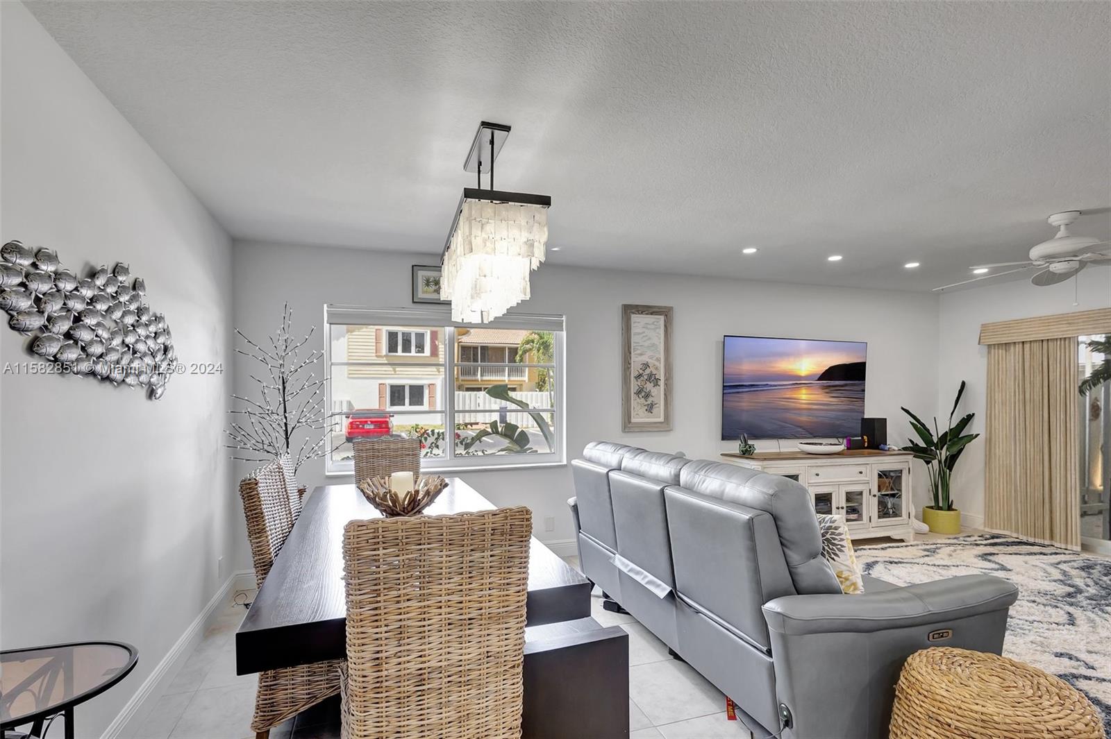 237 Seabreeze Circle Jupiter, FL 33477 - Photo 16 of 63 a living room with furniture and a flat screen tv