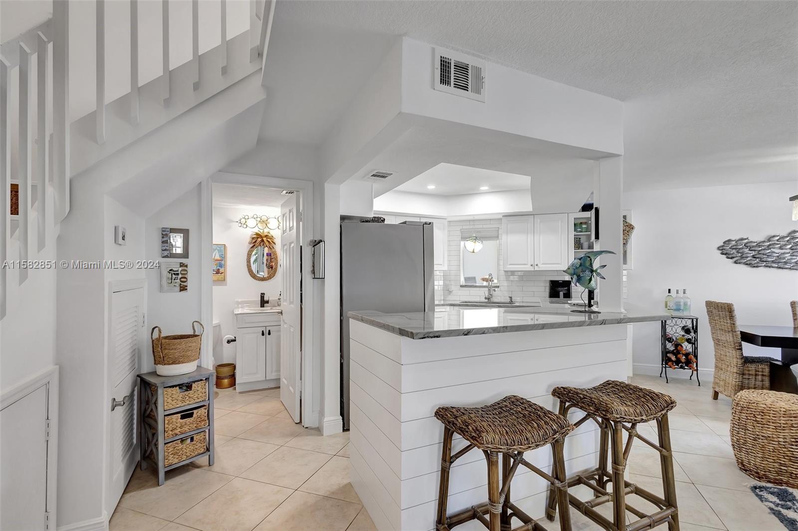 237 Seabreeze Circle Jupiter, FL 33477 - Photo 20 of 63 a kitchen with stainless steel appliances kitchen island granite countertop a refrigerator and a stove top oven