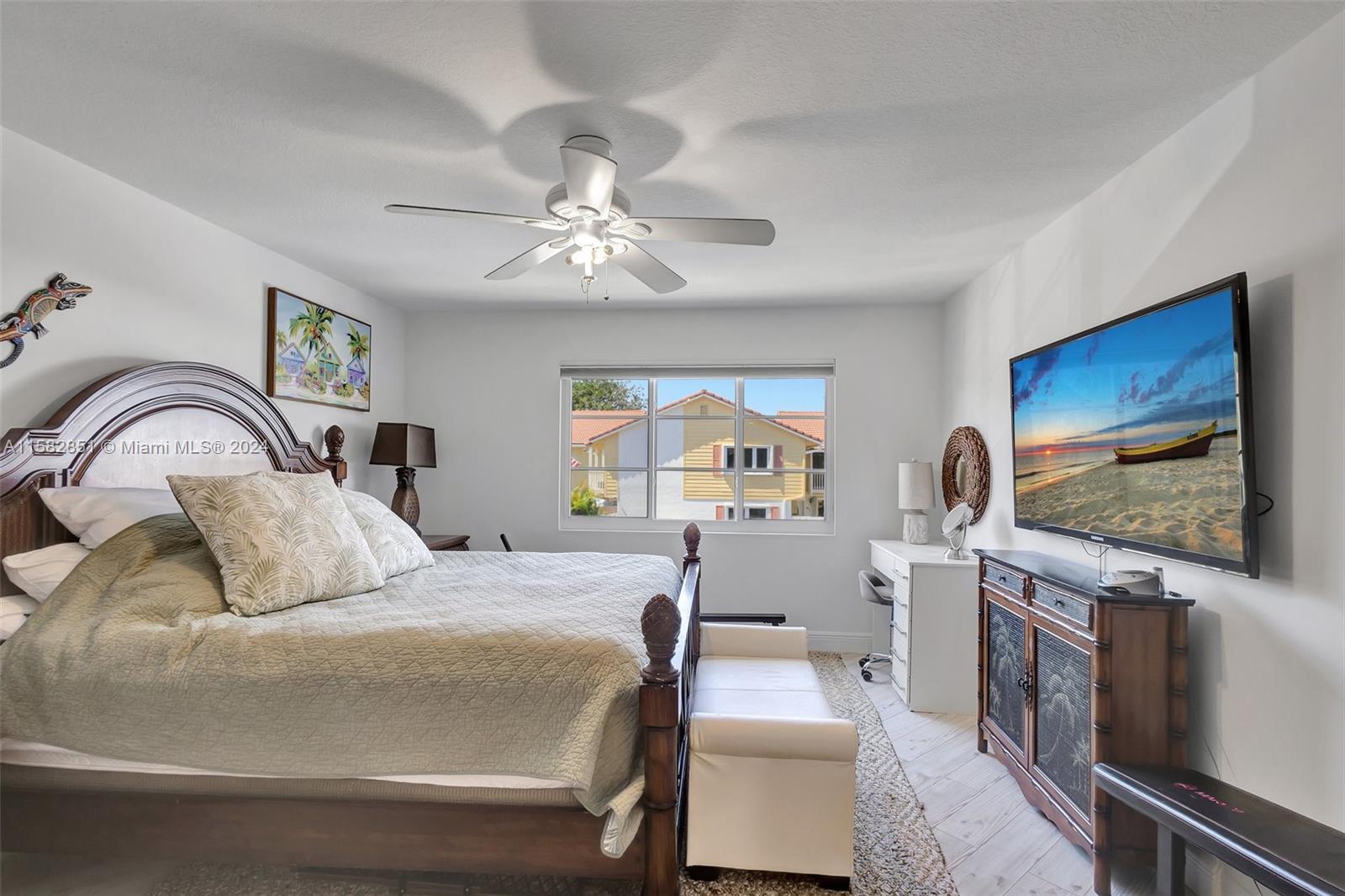 237 Seabreeze Circle Jupiter, FL 33477 - Photo 32 of 63 a bedroom with a bed and a flat screen tv
