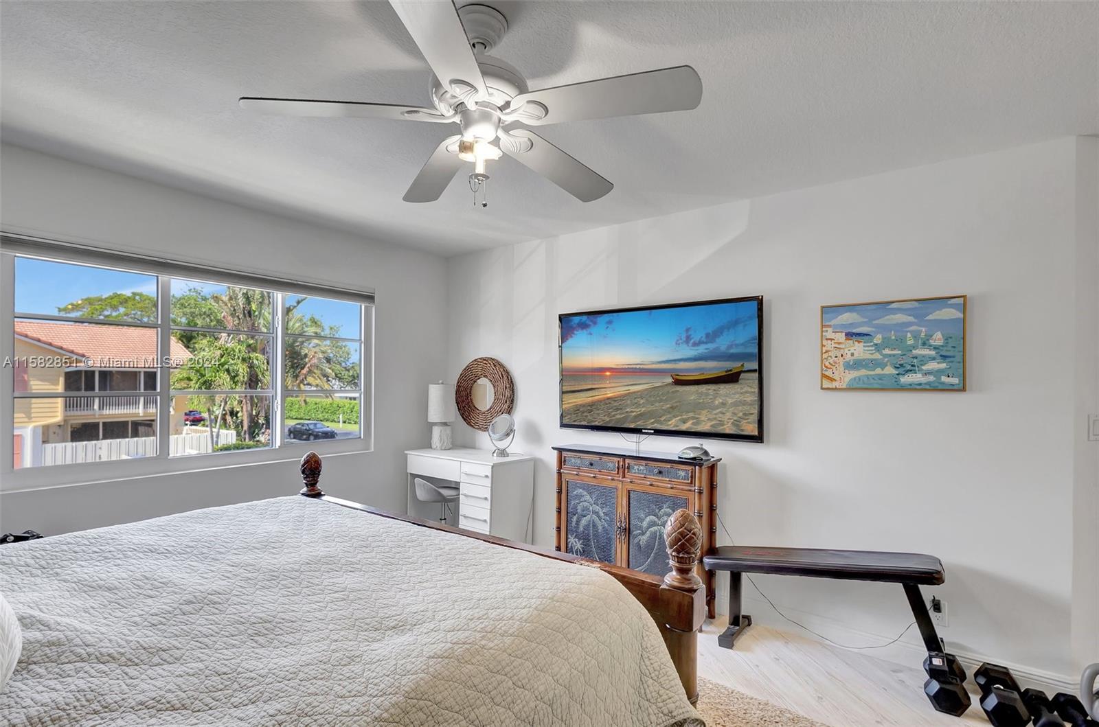 237 Seabreeze Circle Jupiter, FL 33477 - Photo 34 of 63 a bedroom with a bed and a flat screen tv