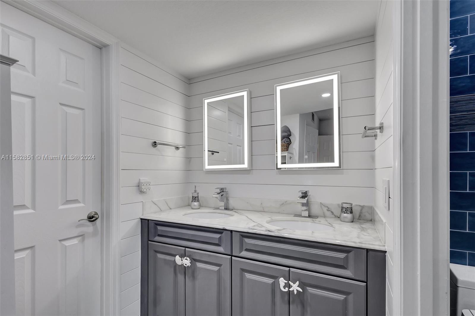 237 Seabreeze Circle Jupiter, FL 33477 - Photo 35 of 63 a bathroom with a granite countertop sink a mirror and a