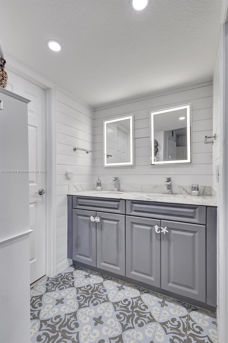 237 Seabreeze Circle Jupiter, FL 33477 - Photo 37 of 63 a spacious bathroom with a sink and a mirror