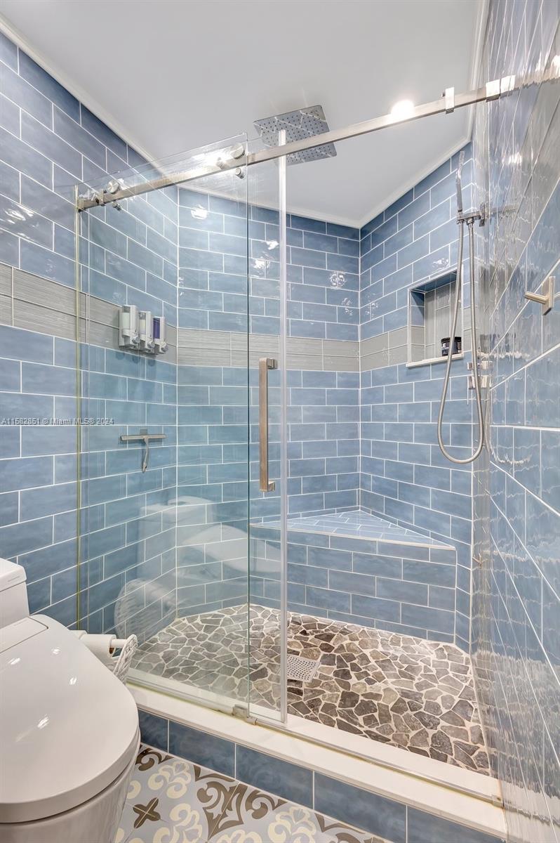 237 Seabreeze Circle Jupiter, FL 33477 - Photo 38 of 63 a bathroom with a sink a toilet and shower