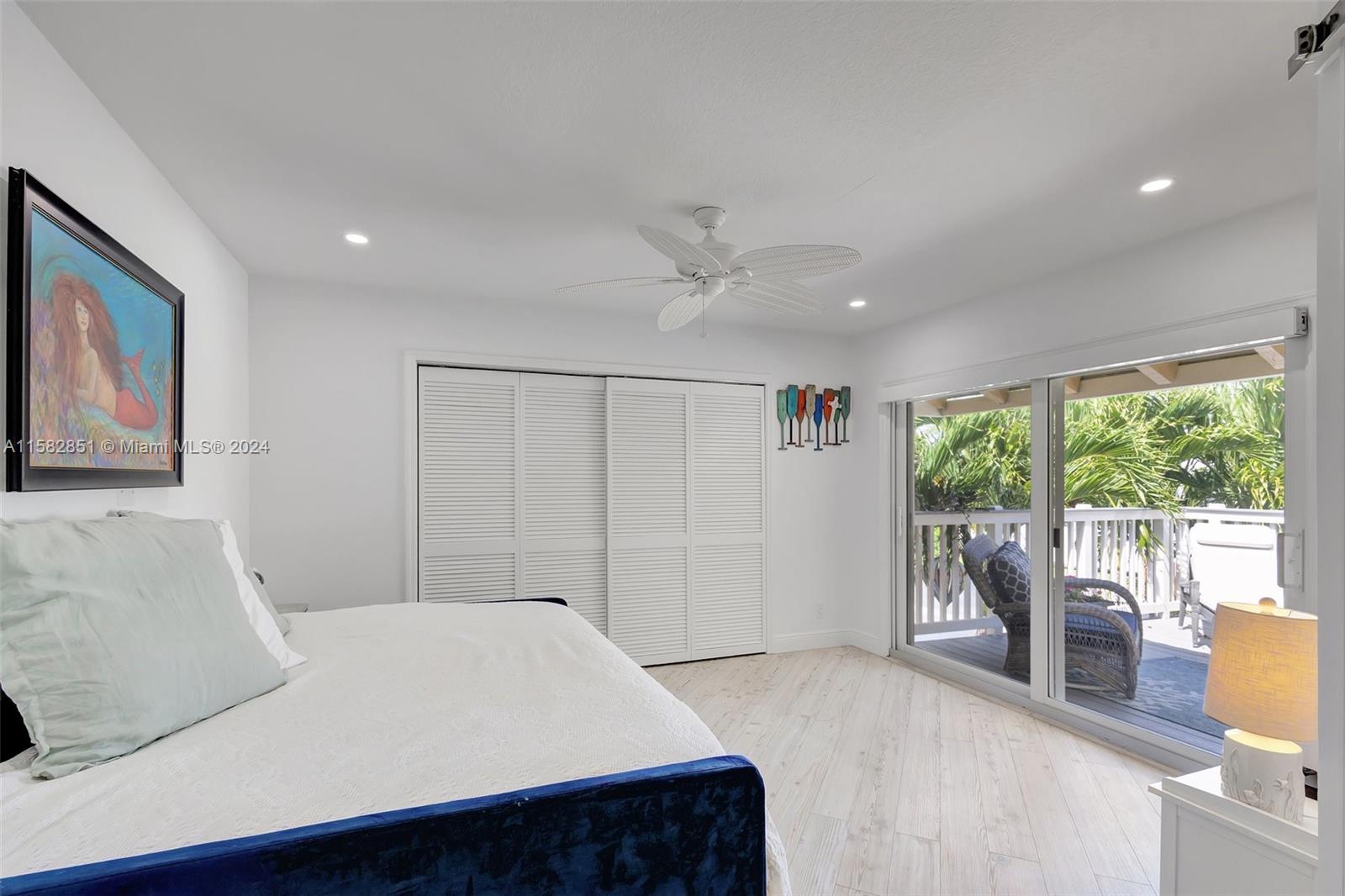 237 Seabreeze Circle Jupiter, FL 33477 - Photo 39 of 63 a bedroom with a large bed and a large window
