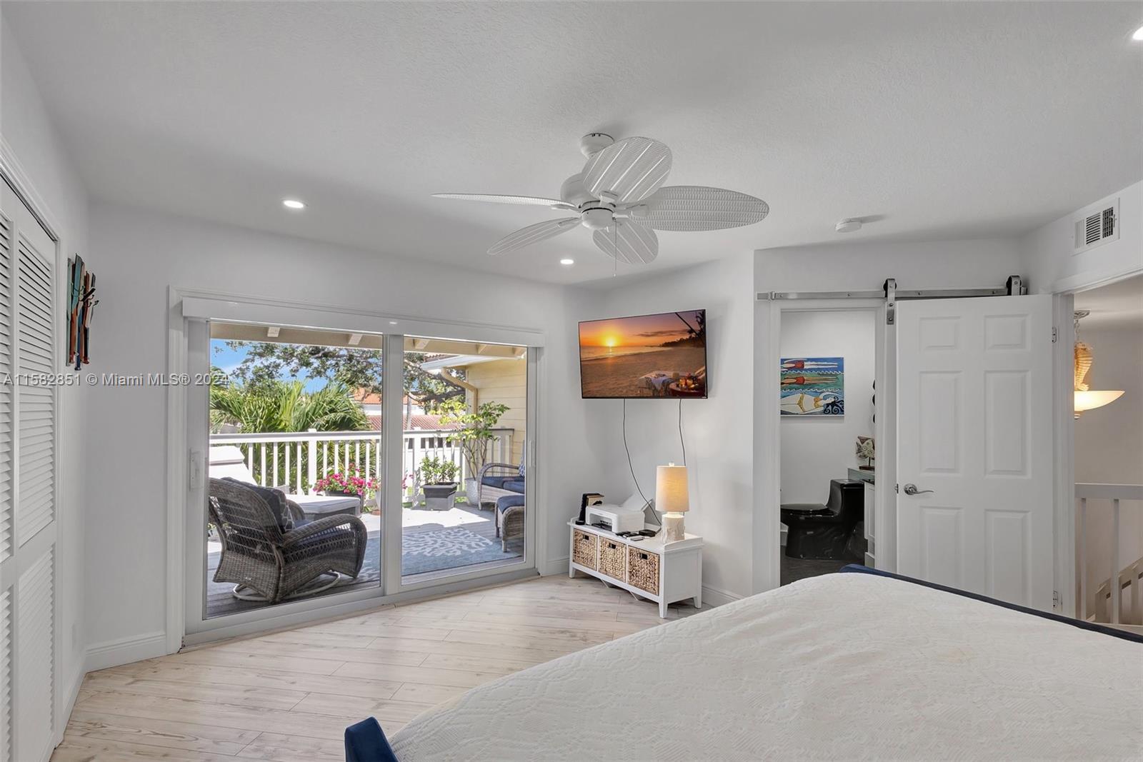 237 Seabreeze Circle Jupiter, FL 33477 - Photo 40 of 63 a bedroom with furniture and a large window