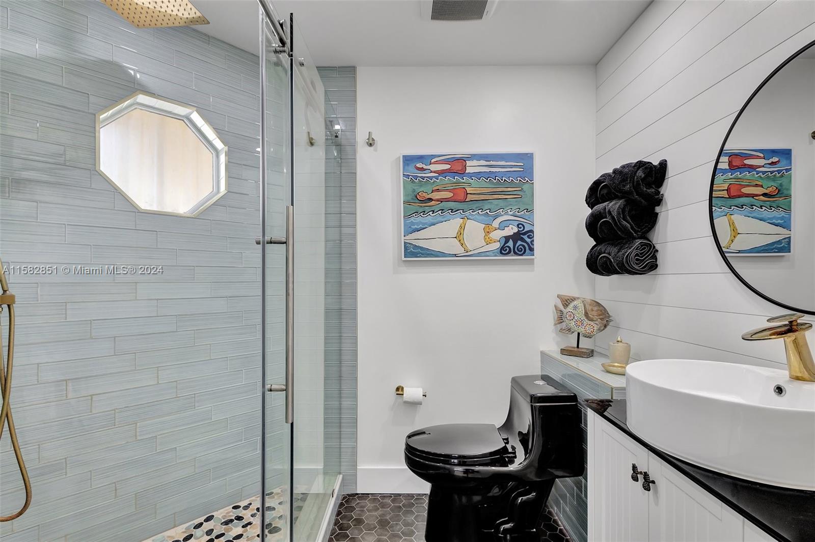 237 Seabreeze Circle Jupiter, FL 33477 - Photo 42 of 63 a bathroom with a sink mirror and toilet