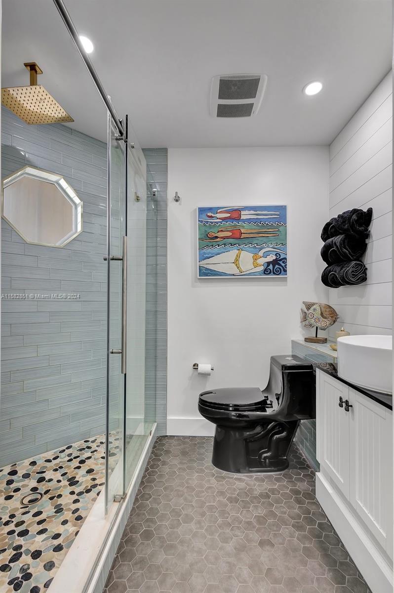 237 Seabreeze Circle Jupiter, FL 33477 - Photo 43 of 63 a living room with a couch and a chandelier