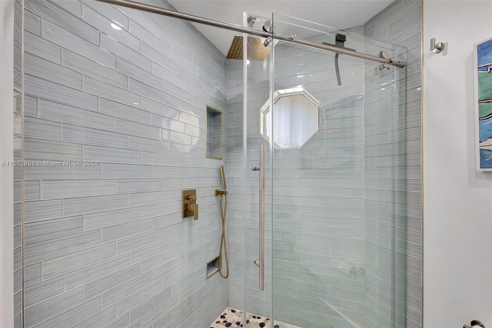 237 Seabreeze Circle Jupiter, FL 33477 - Photo 44 of 63 a bathroom with a shower and a mirror