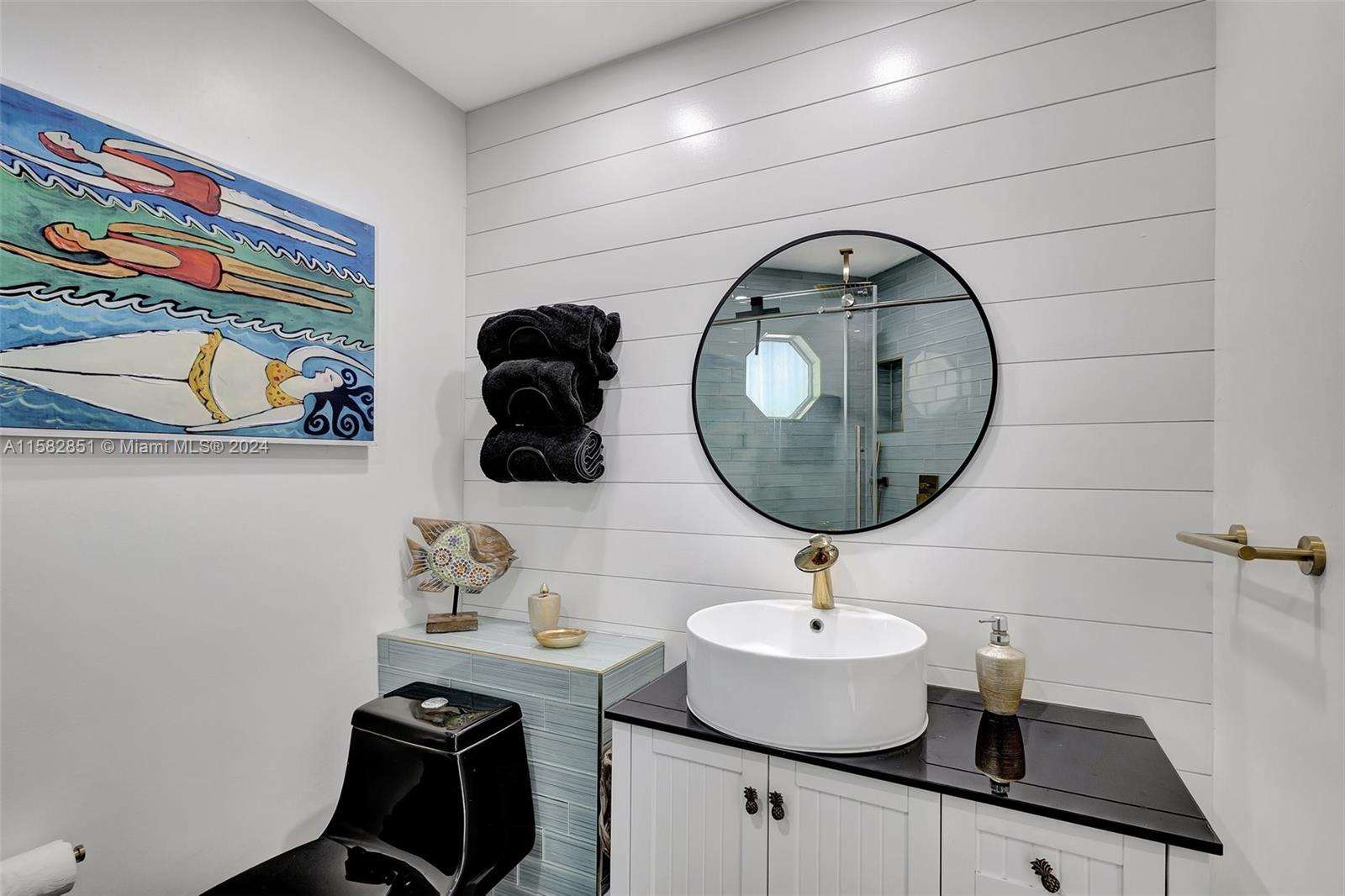 237 Seabreeze Circle Jupiter, FL 33477 - Photo 45 of 63 a bathroom with a sink and a mirror