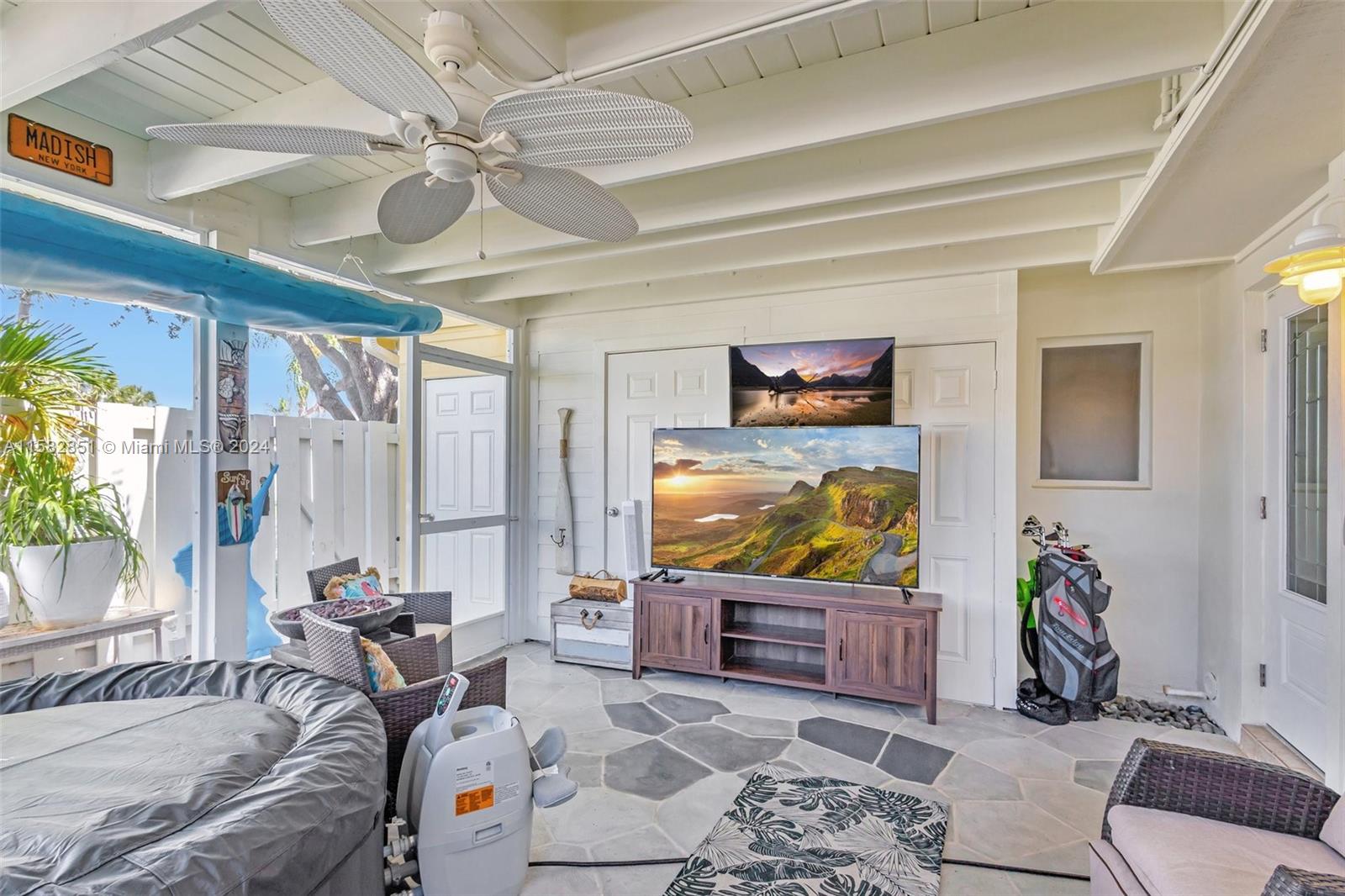 237 Seabreeze Circle Jupiter, FL 33477 - Photo 5 of 63 a living room with furniture and a flat screen tv