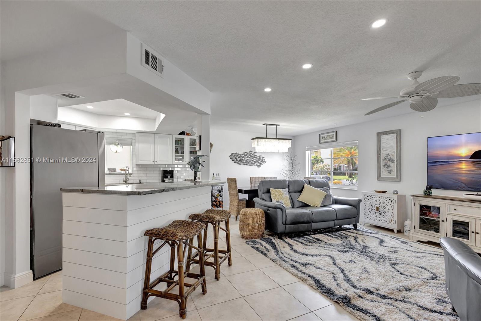 237 Seabreeze Circle Jupiter, FL 33477 - Photo 7 of 63 a living room with furniture and a flat screen tv