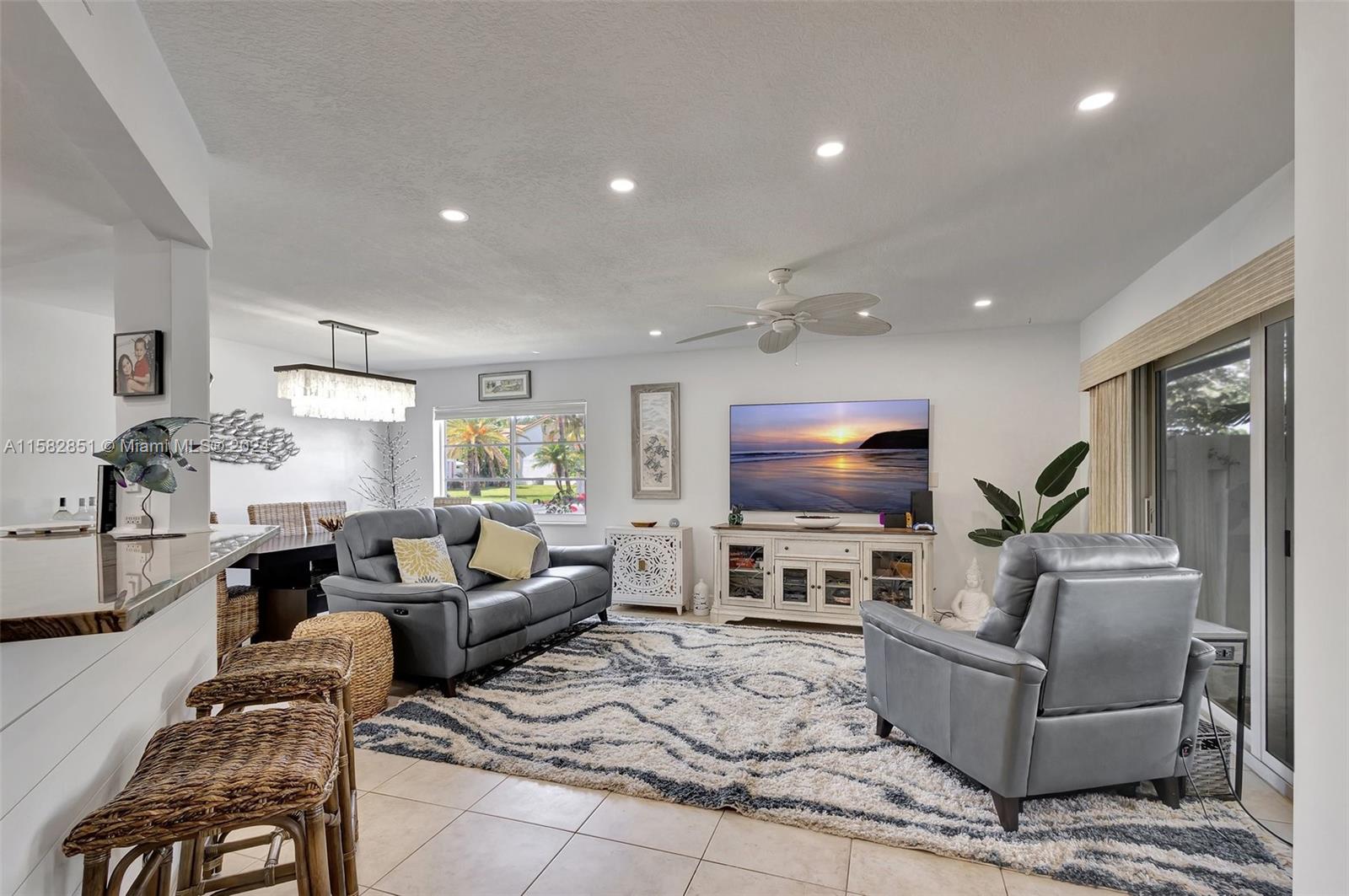 237 Seabreeze Circle Jupiter, FL 33477 - Photo 8 of 63 a living room with furniture and a flat screen tv