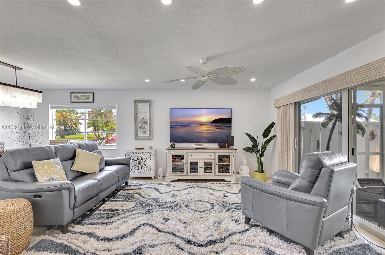 237 Seabreeze Circle Jupiter, FL 33477 - Photo 9 of 63 a living room with furniture and a flat screen tv