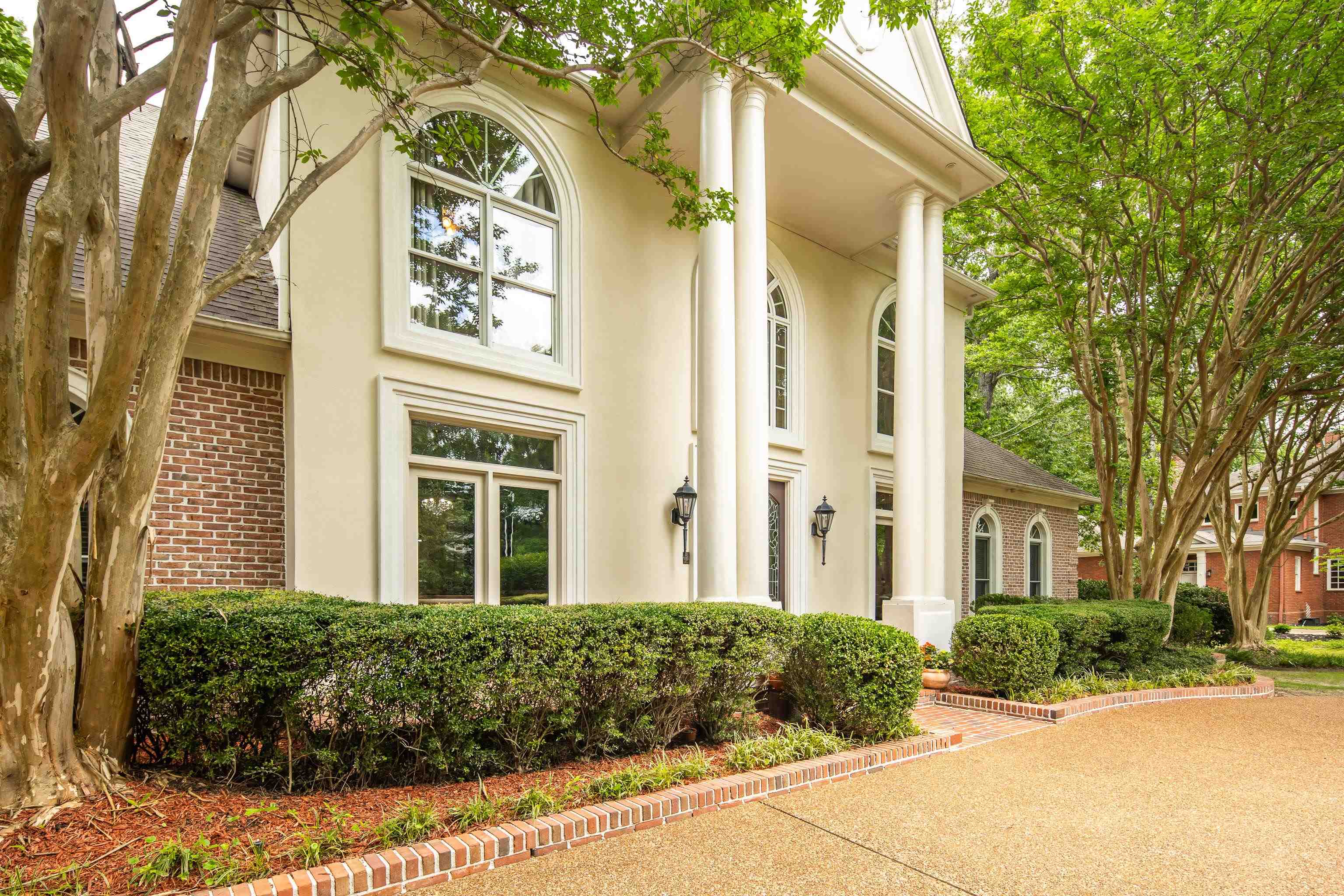 350 Bluff Ridge Cove Memphis, TN 38018 - Photo 5 of 37 Stucco and brick facade featuring a portico with four columns and arched windows