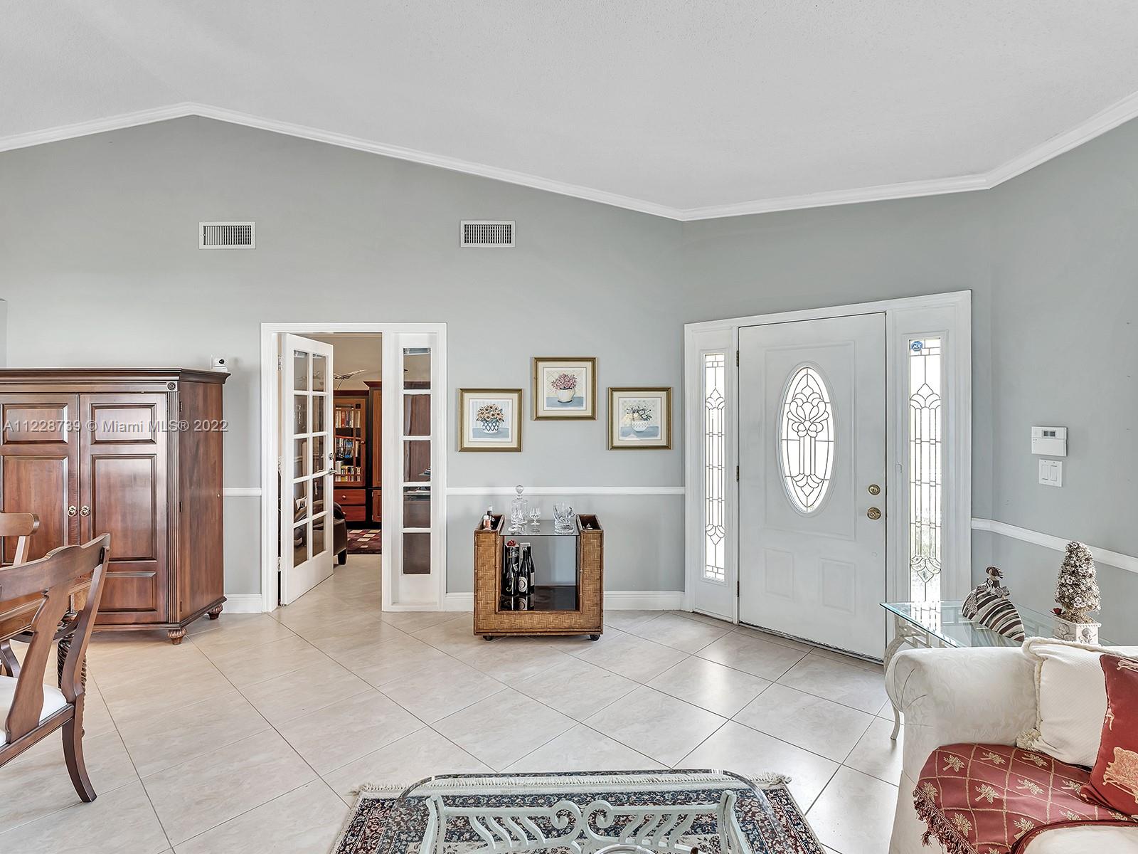 11291 Southwest 62nd Terrace Miami, FL 33173 - Photo 24 of 65 a living room with furniture and a window