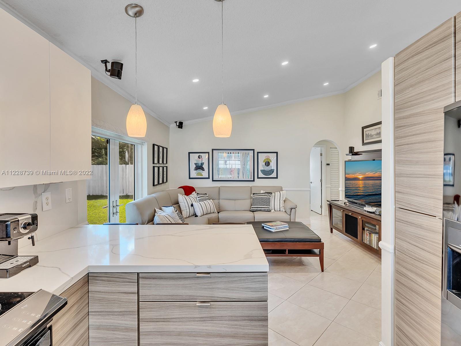 11291 Southwest 62nd Terrace Miami, FL 33173 - Photo 30 of 65 a living room with furniture and a kitchen area