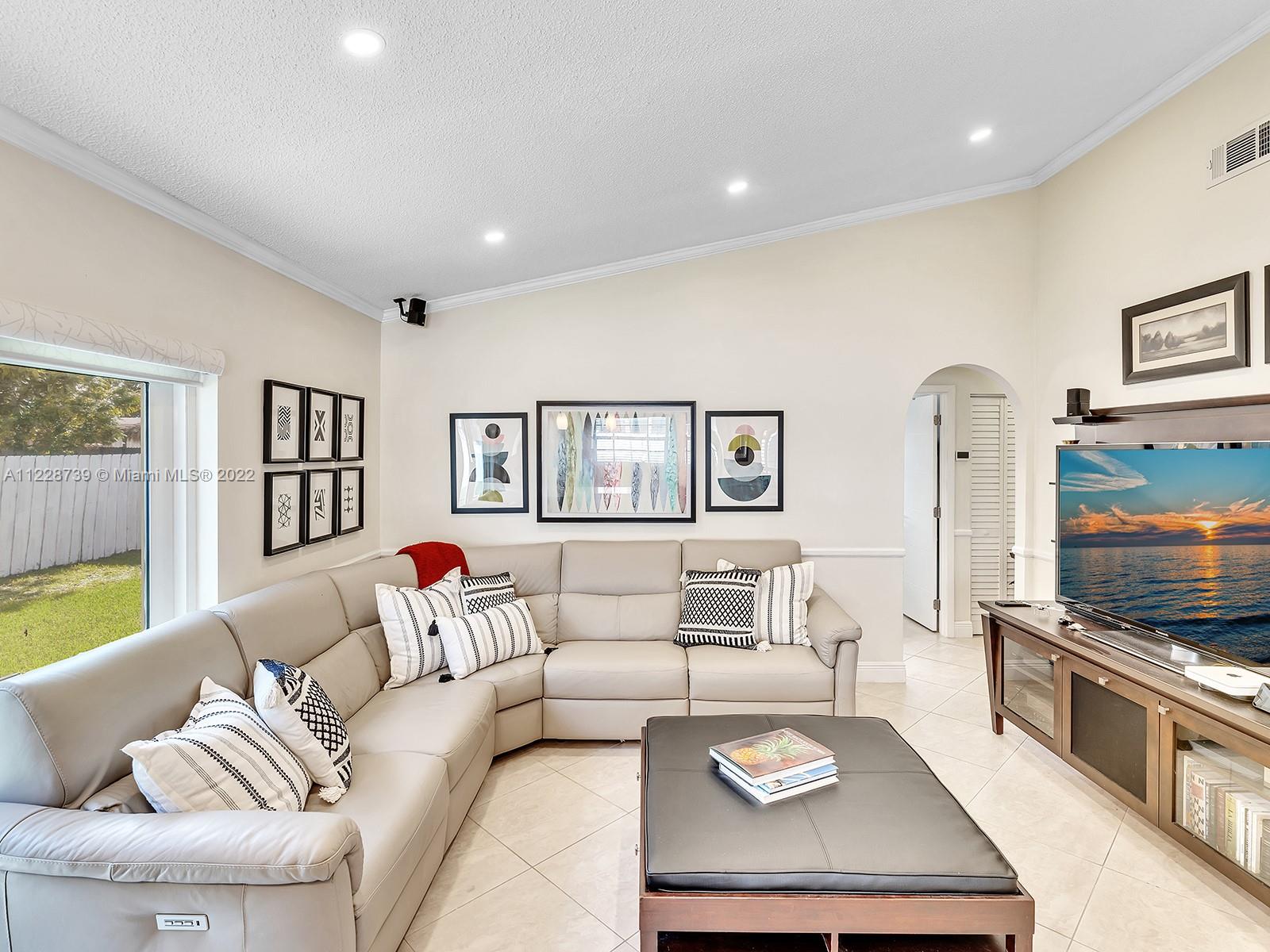 11291 Southwest 62nd Terrace Miami, FL 33173 - Photo 34 of 65 a living room with furniture and a flat screen tv