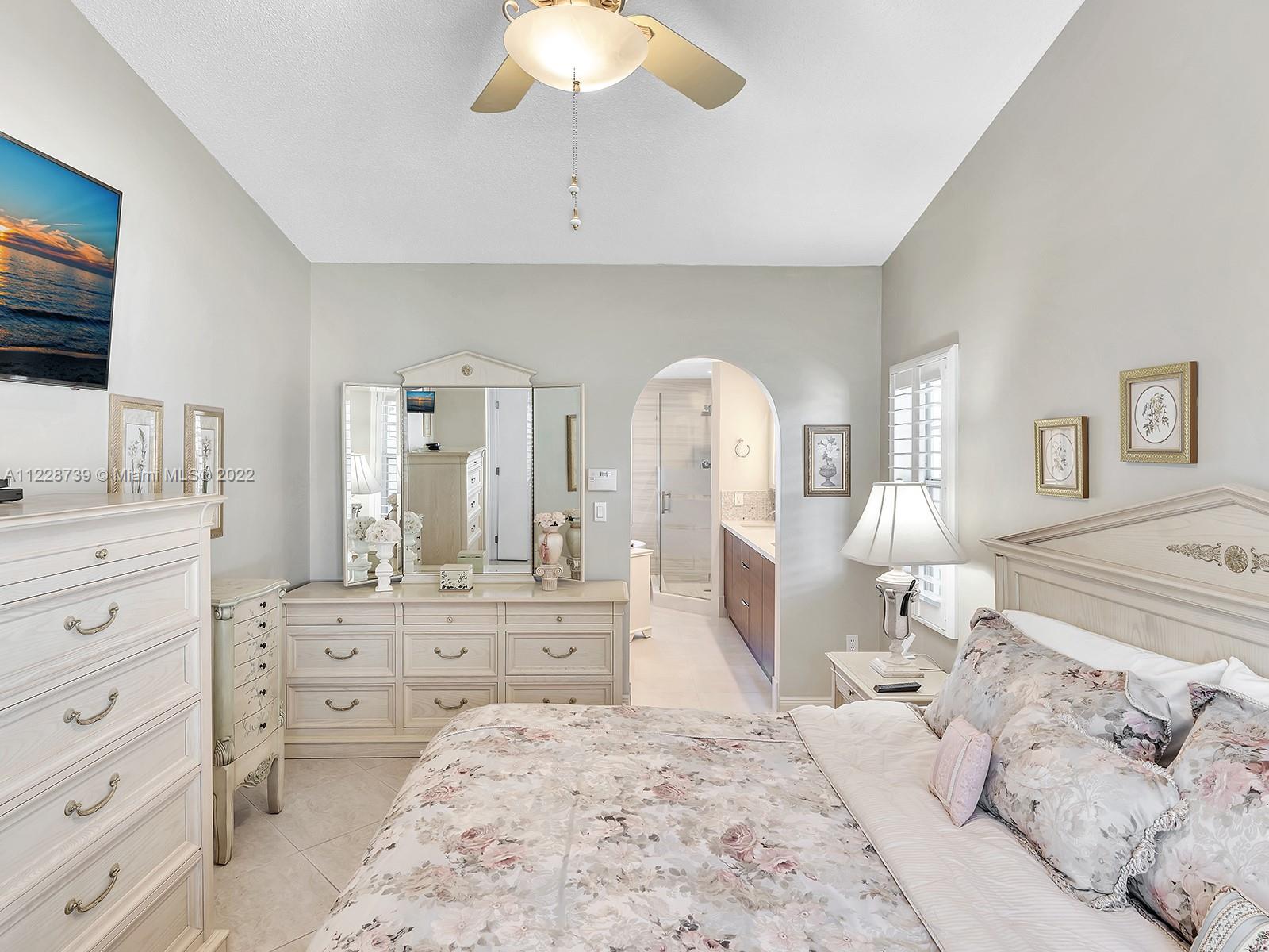 11291 Southwest 62nd Terrace Miami, FL 33173 - Photo 37 of 65 a large bedroom with a large bed and a flat screen tv