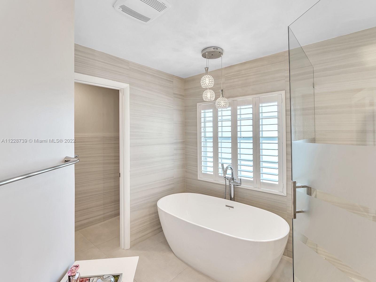 11291 Southwest 62nd Terrace Miami, FL 33173 - Photo 39 of 65 a bathroom with a bathtub and shower