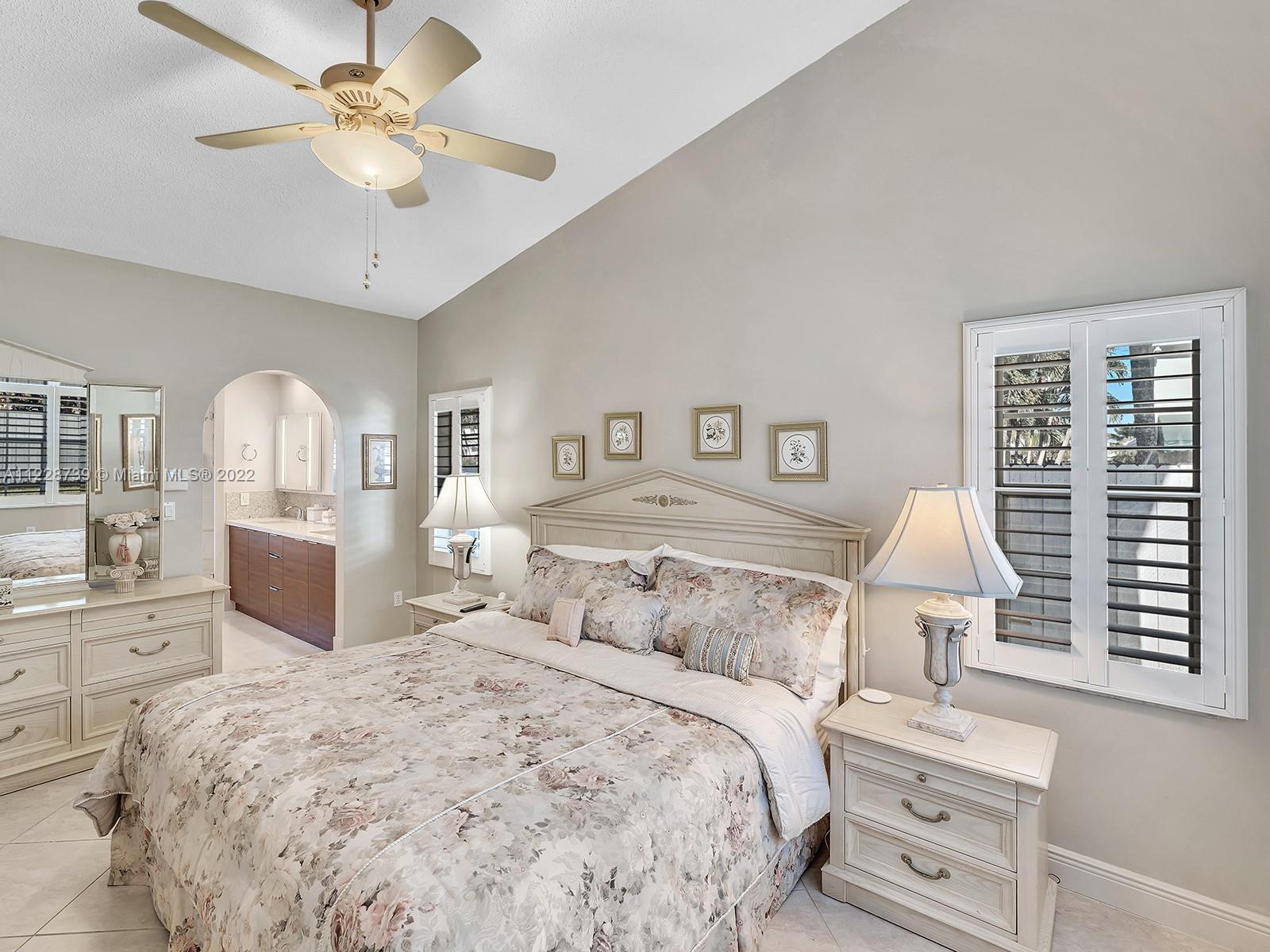 11291 Southwest 62nd Terrace Miami, FL 33173 - Photo 4 of 65 a bedroom with a large bed and a chandelier