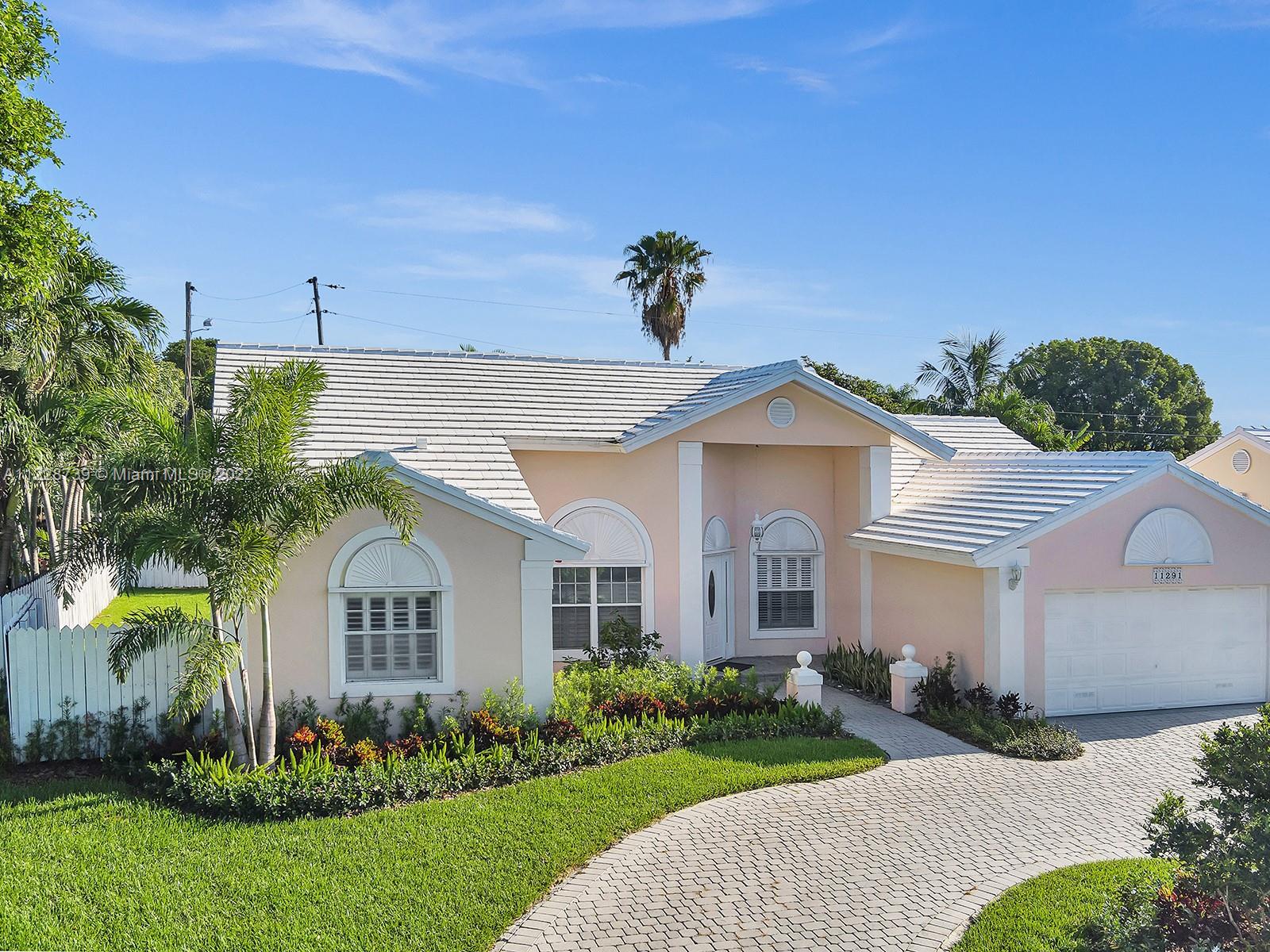 11291 Southwest 62nd Terrace Miami, FL 33173 - Photo 56 of 65 a front view of a house with a yard and garage