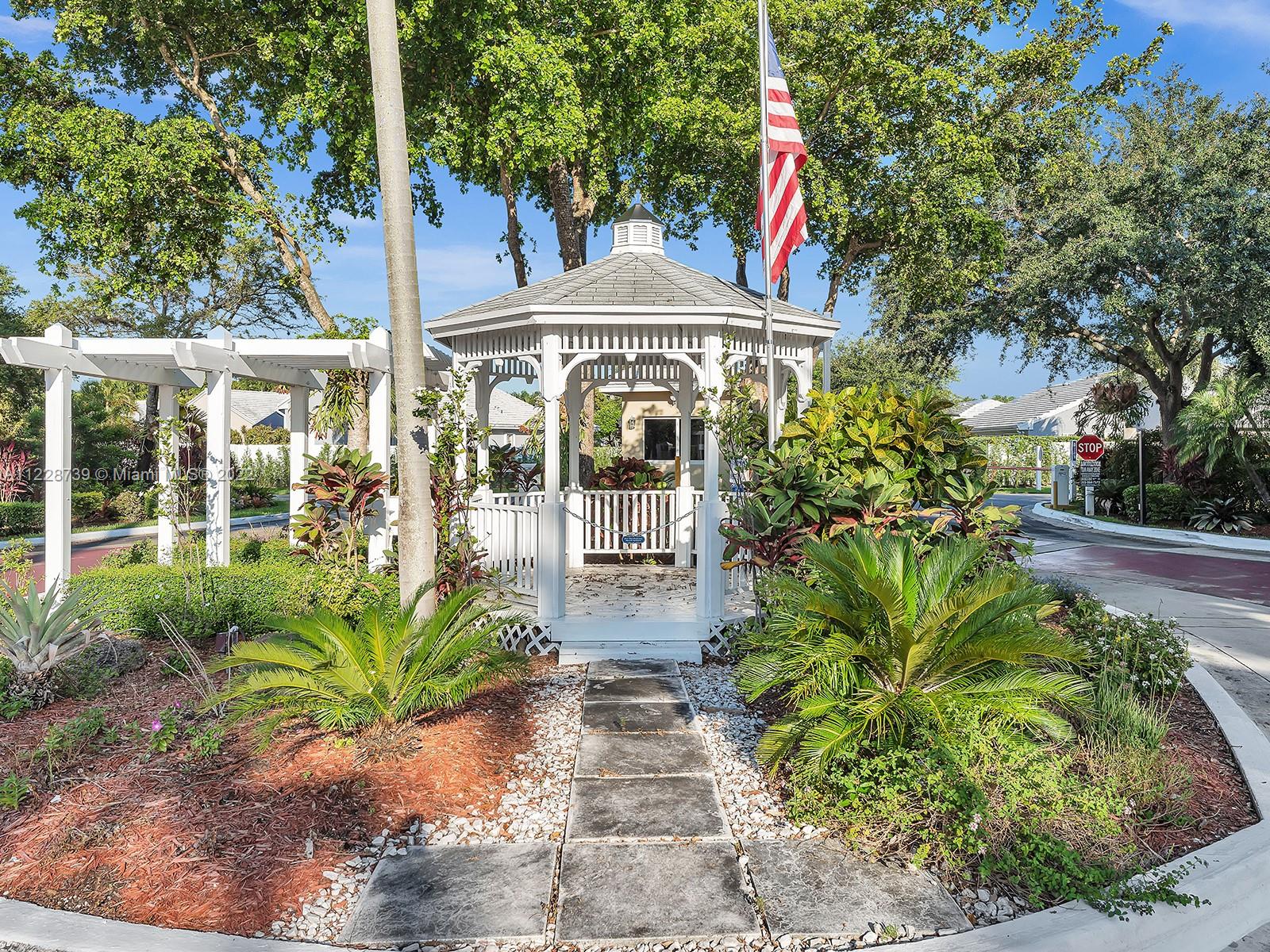 11291 Southwest 62nd Terrace Miami, FL 33173 - Photo 7 of 65 a front view of a house with a yard and potted plants