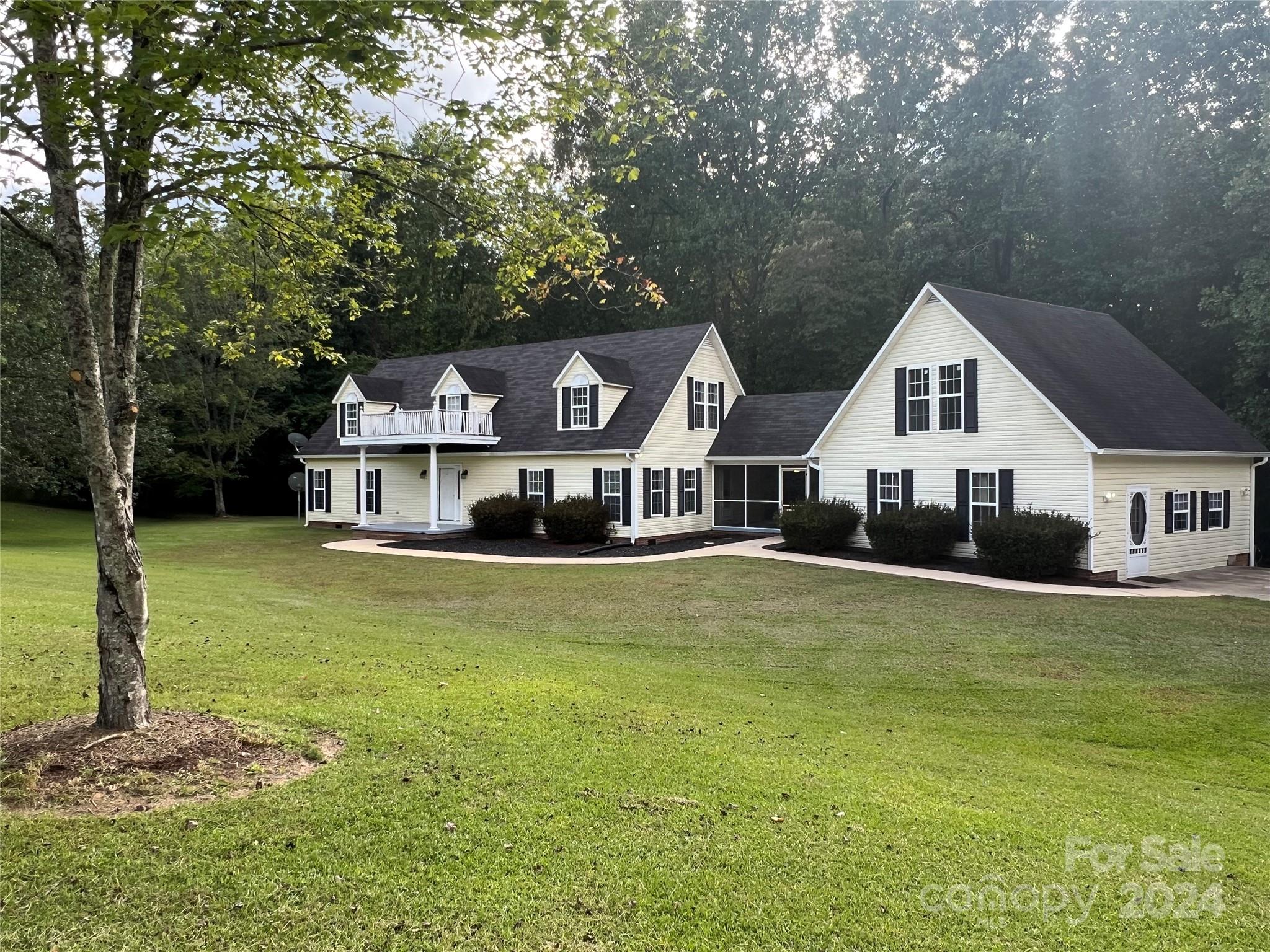 148 Riff Drive Forest City, NC 28043 - Photo 1 of 40 a front view of a house with a garden and trees