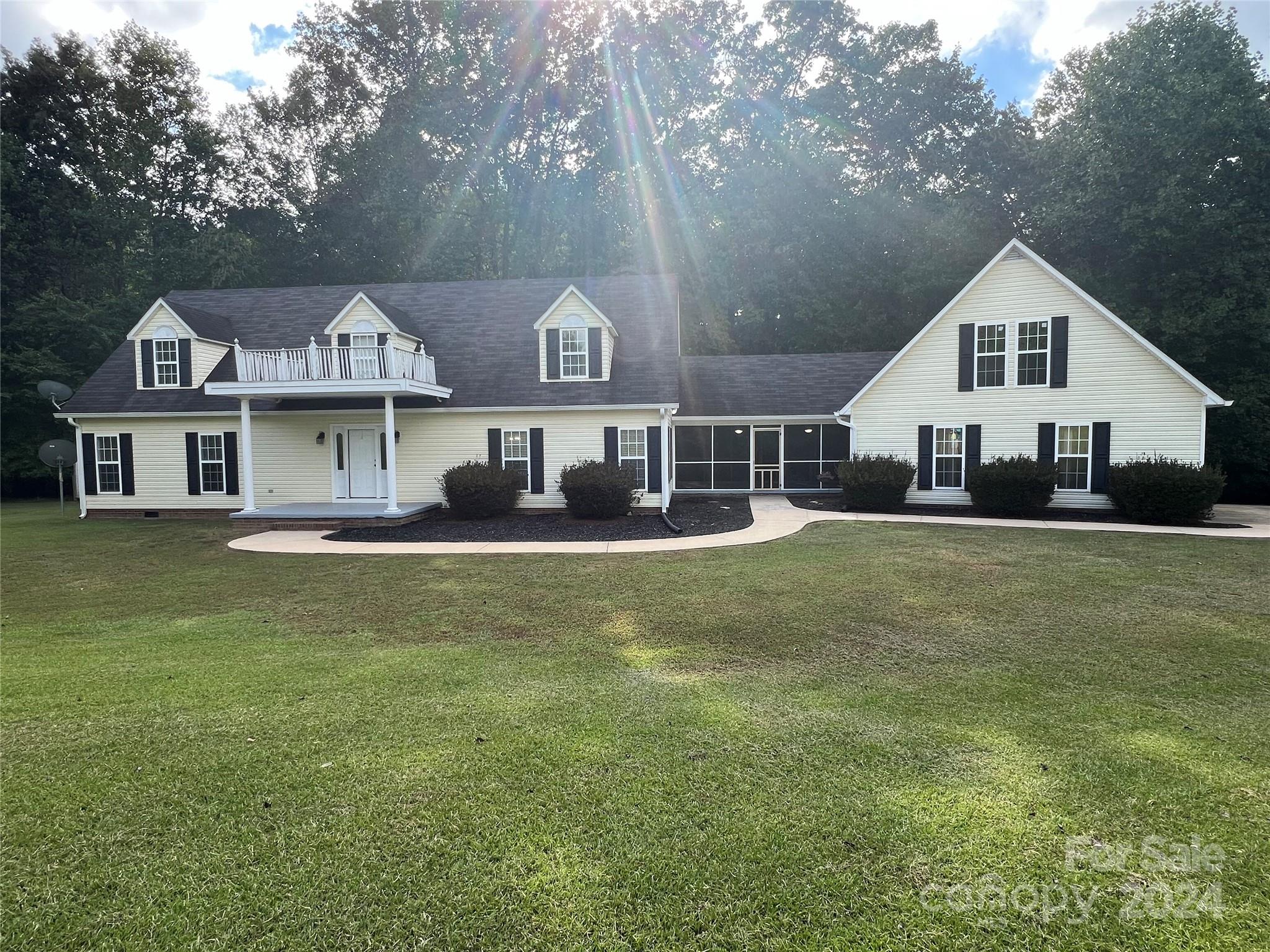 148 Riff Drive Forest City, NC 28043 - Photo 2 of 40 a front view of a house with a garden and trees