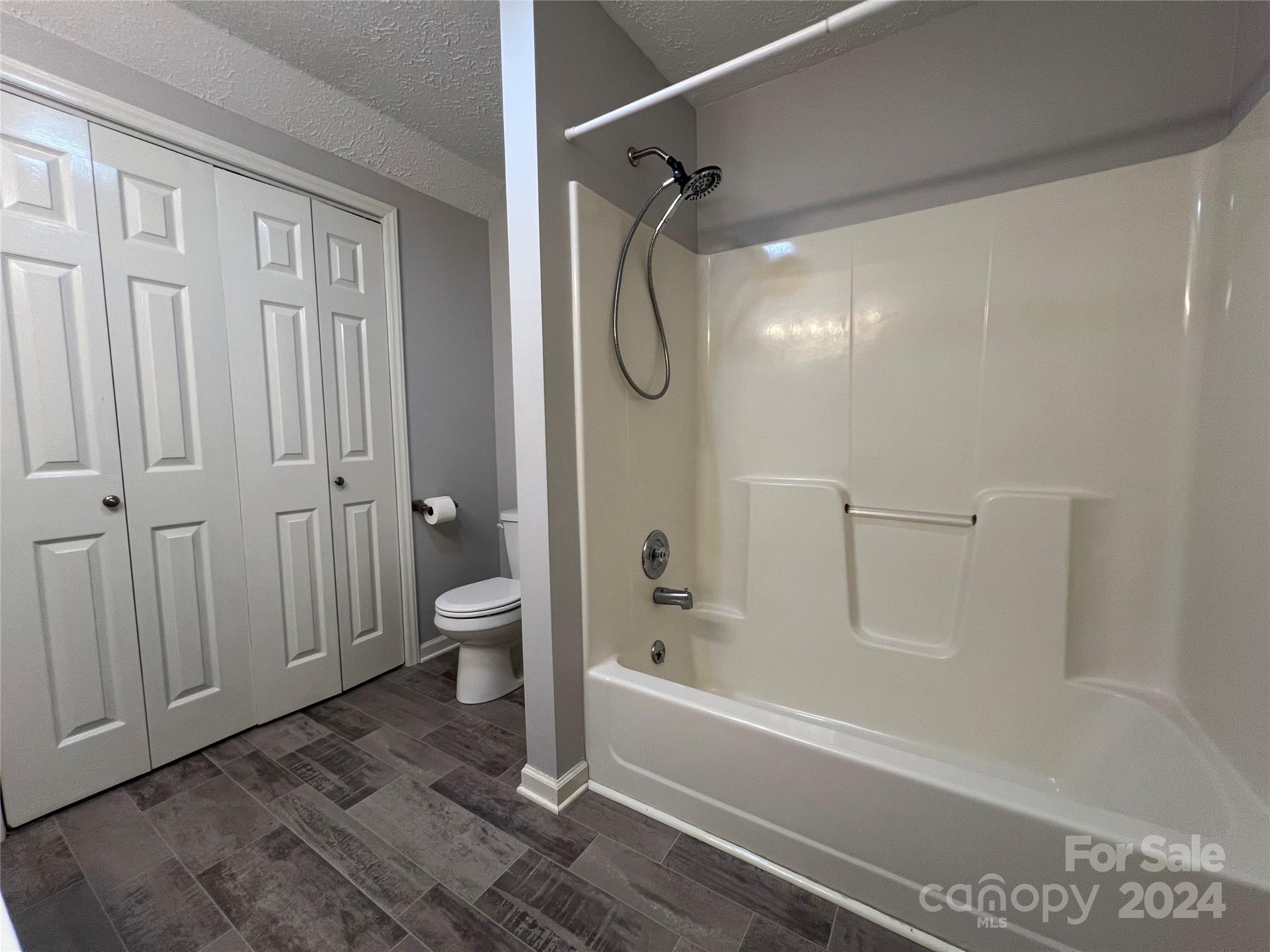 148 Riff Drive Forest City, NC 28043 - Photo 23 of 40 a bathroom with a granite countertop bathtub shower and toilet
