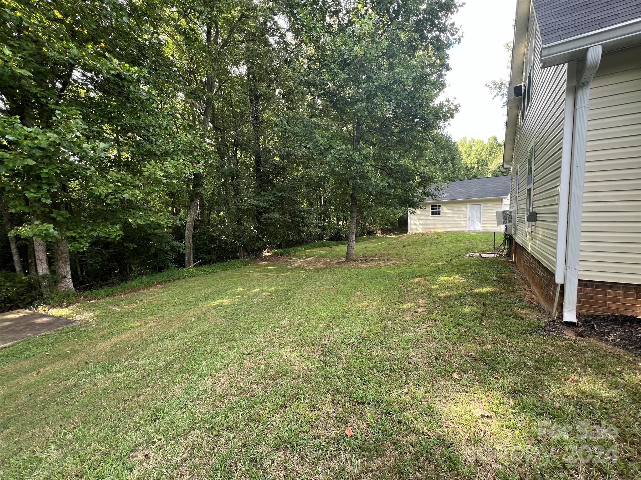 148 Riff Drive Forest City, NC 28043 - Photo 37 of 40 a view of a backyard with a large tree