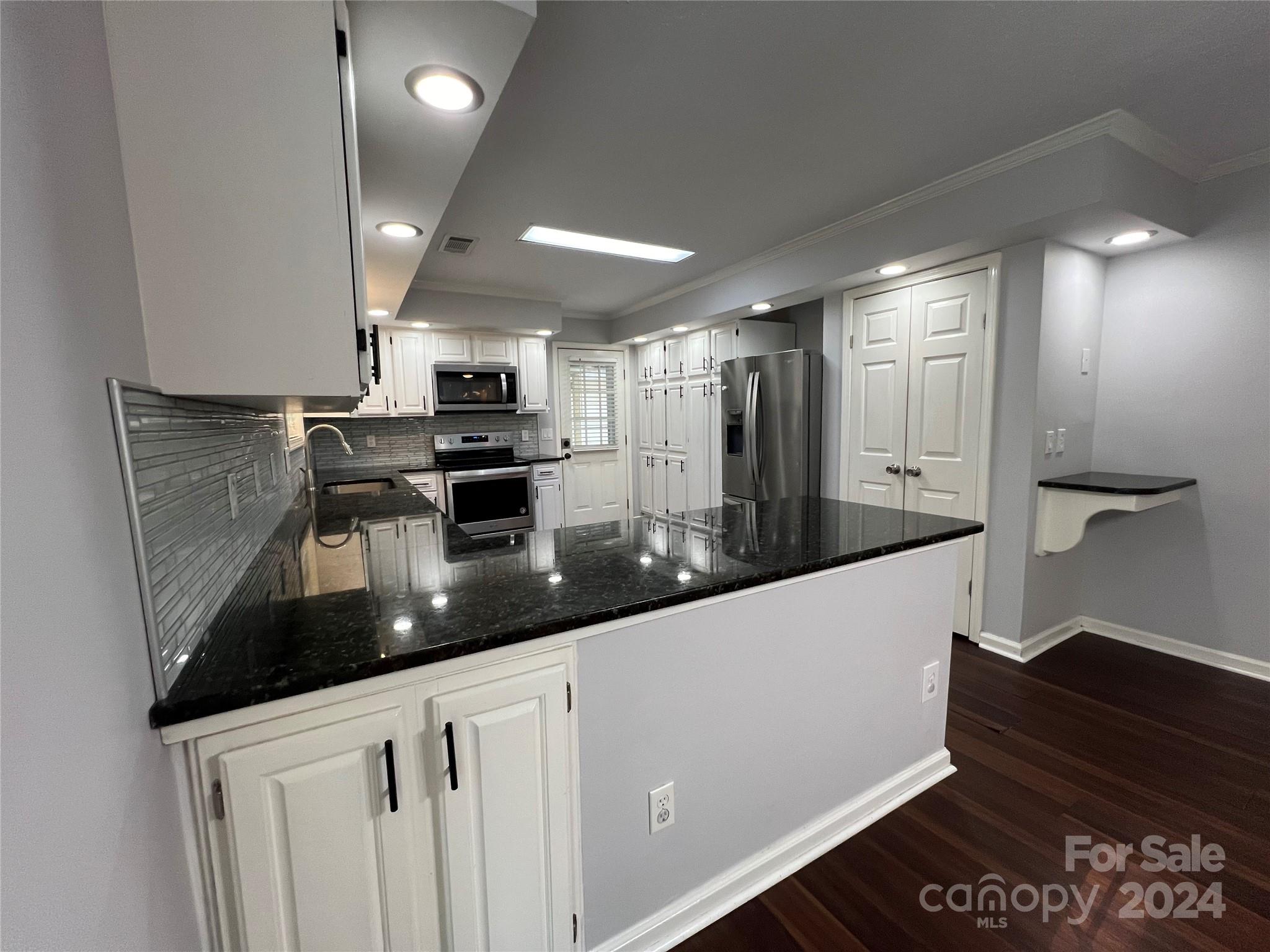 148 Riff Drive Forest City, NC 28043 - Photo 5 of 40 a kitchen with stainless steel appliances granite countertop a sink and a stove