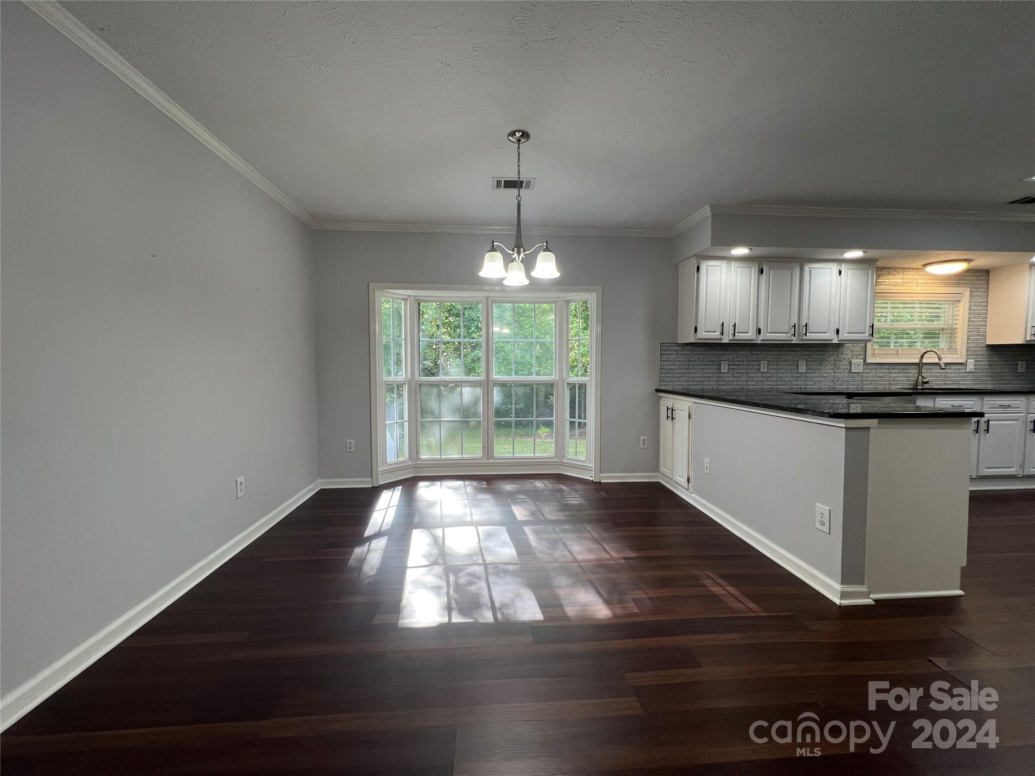 148 Riff Drive Forest City, NC 28043 - Photo 6 of 40 a kitchen with granite countertop wooden floors and wide window